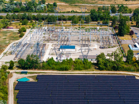 Aerial view of the Solarfeld solar farm and adjacent electrical substation with power lines and transformers in Hombourg Grand Est France.