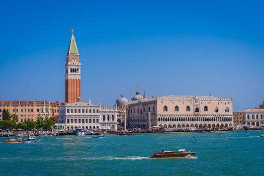 Venice Italy 29 March 2026 View of the iconic St. Mark s Campanile rising against a deep blue sky mirrored in the bustling turquoise waters of the lagoon. Venice Italy 29 March 2026 View of the iconic St. Mark s Campanile rising against a deep blue sky mirrored in the bustling turquoise waters of the lagoon.