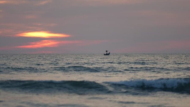 View of a small boat on the sea at sunset in Bangladesh. View of a small boat on the sea at sunset in Bangladesh.