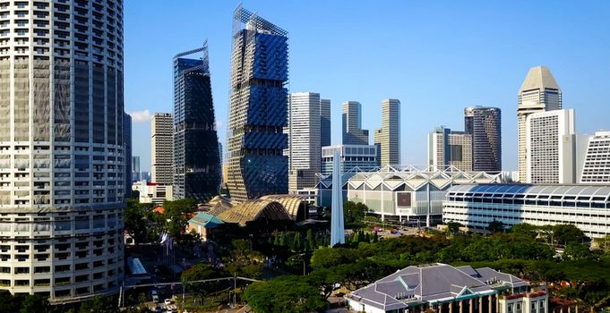 Aerial view of JW Marriott Hotel Singapore South Beach and surrounding modern skyscrapers lush greenery and urban architecture under a clear blue sky in Singapore Singapore.