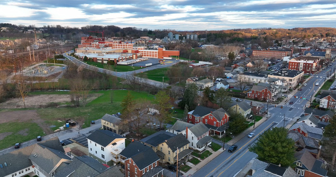 Aerial view of downtown Elizabethtown featuring residential neighborhoods a main road and industrial facilities under a cloudy sky in Elizabethtown Pennsylvania United States. Aerial view of downtown Elizabethtown featuring residential neighborhoods a main road and industrial facilities under a cloudy sky in Elizabethtown Pennsylvania United States.