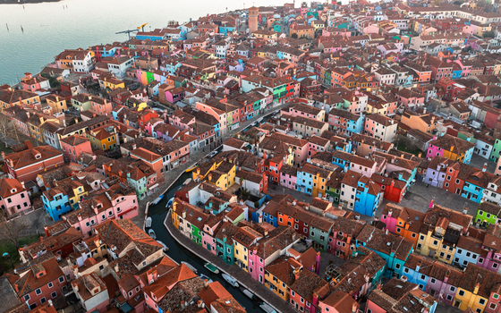 Aerial view of the colorful houses of Burano island with narrow canals and terracotta rooftops in the Venetian lagoon Venice Veneto Italy.