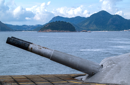 Rio de Janeiro Brazil 02 June 2026 View of the historic artillery cannons at Copacabana Fort overlooking the Atlantic Ocean with green mountains and islands in the background.