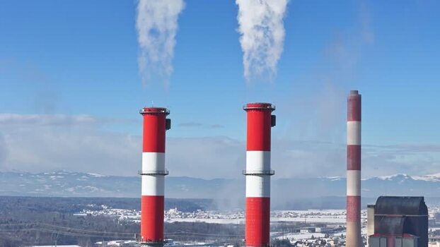 Aerial view of industrial chimneys with smoke in Wildon Austria.