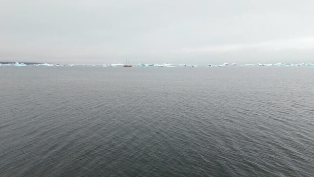 Aerial view of a boat among icebergs off Disko Island Greenland. Aerial view of a boat among icebergs off Disko Island Greenland.