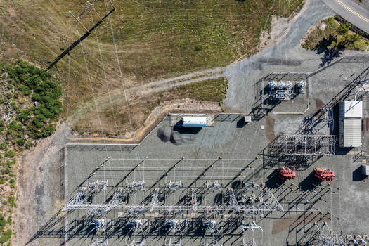 Aerial view of an electrical substation with power lines transformers and gravel ground in Bandon Oregon United States. Aerial view of an electrical substation with power lines transformers and gravel ground in Bandon Oregon United States.