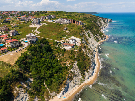 Aerial view of the White Cliffs of Byala featuring coastal residential buildings lush greenery and sandy beaches along the Black Sea in Byala Varna Bulgaria. Aerial view of the White Cliffs of Byala featuring coastal residential buildings lush greenery and sandy beaches along the Black Sea in Byala Varna Bulgaria.