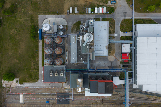 Aerial view of an industrial facility featuring silos complex piping systems and a large warehouse building Breclav South Moravian Region Czechia.