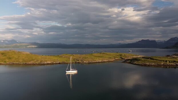 Aerial view of a sailboat in a bay in Senja Norway.