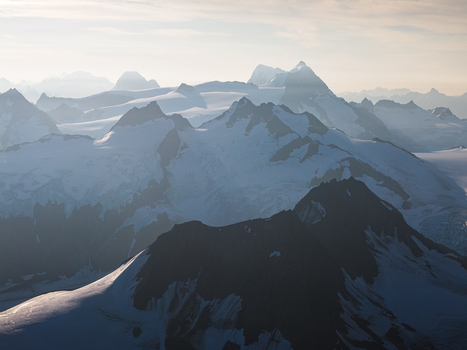 Aerial view of the snow capped peaks and glaciers of Chugach State Park under soft light in Anchorage Alaska United States. Aerial view of the snow capped peaks and glaciers of Chugach State Park under soft light in Anchorage Alaska United States.