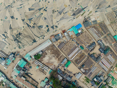 Cox s Bazar Bangladesh 11 March 2026 Aerial view of fishing nets spread on the sand and traditional coastal buildings in a fishing village. Cox s Bazar Bangladesh 11 March 2026 Aerial view of fishing nets spread on the sand and traditional coastal buildings in a fishing village.