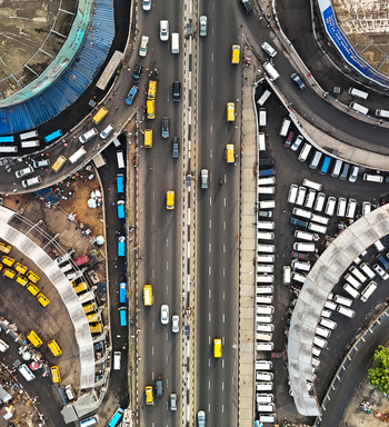 Aerial view of a bustling highway bisecting a city with cars like tiny jewels amidst the urban tapestry Mumbai Maharashtra India. Aerial view of a bustling highway bisecting a city with cars like tiny jewels amidst the urban tapestry Mumbai Maharashtra India.