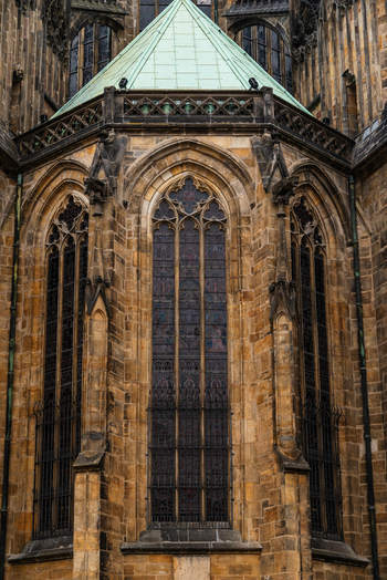 View of the intricate Gothic stone masonry and stained glass windows of St. Vitus Cathedral in Prague Prague Czechia.