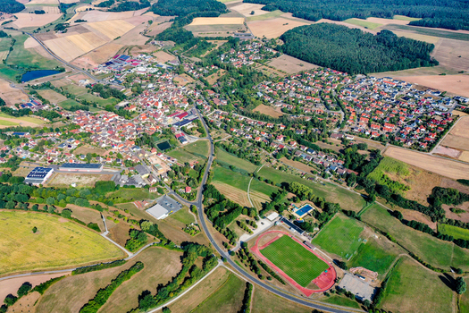 Aerial view of the town of Burghaslach with its red tiled roofs and sports field in the municipality of Burghaslach Bavaria Germany. Aerial view of the town of Burghaslach with its red tiled roofs and sports field in the municipality of Burghaslach Bavaria Germany.