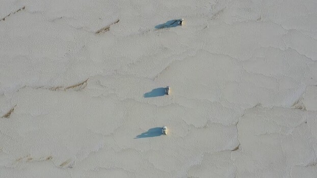 Aerial view of vehicles driving across salt flats Ethiopia. Aerial view of vehicles driving across salt flats Ethiopia.