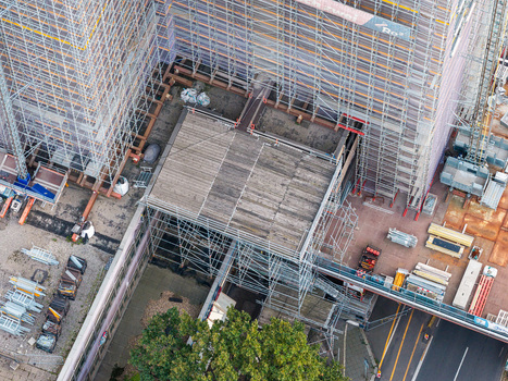 Aerial view of the Steglitzer Kreisel skyscraper under extensive renovation with scaffolding surrounding the structure in Berlin Berlin Germany. Aerial view of the Steglitzer Kreisel skyscraper under extensive renovation with scaffolding surrounding the structure in Berlin Berlin Germany.