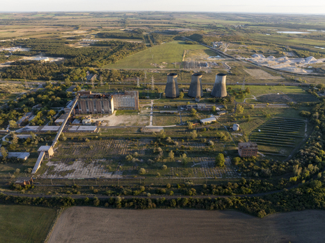 Aerial view of the abandoned Inota Power Plant with its iconic cooling towers industrial buildings and surrounding landscape in Varpalota Hungary. Aerial view of the abandoned Inota Power Plant with its iconic cooling towers industrial buildings and surrounding landscape in Varpalota Hungary.