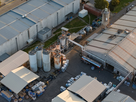Melbourne VIC Australia 22 September 2026 Aerial view of industrial factory buildings in Kilsyth with large storage tanks metal roofing and a tanker truck in the yard. Melbourne VIC Australia 22 September 2026 Aerial view of industrial factory buildings in Kilsyth with large storage tanks metal roofing and a tanker truck in the yard.