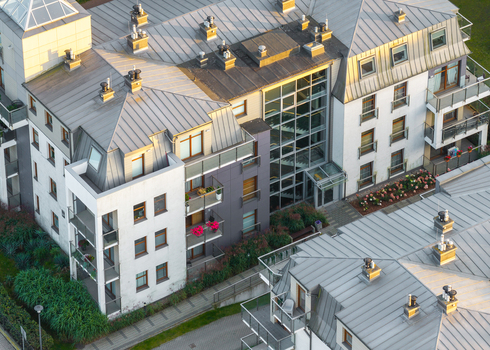 Aerial view of modern residential apartment buildings with metal roofs balconies and glass facades in Sopot Pomeranian Voivodeshi Poland. Aerial view of modern residential apartment buildings with metal roofs balconies and glass facades in Sopot Pomeranian Voivodeshi Poland.