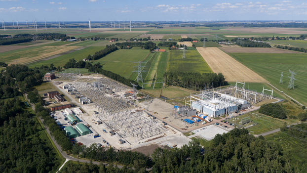 Aerial view of the Hoogspanningsstation electrical substation surrounded by agricultural fields and power lines in Meeden Groningen Netherlands.