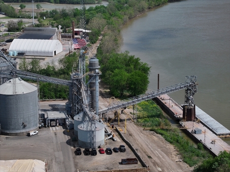 Aerial view of an industrial grain terminal featuring silos and conveyor belts next to a river barge Aurora Indiana United States. Aerial view of an industrial grain terminal featuring silos and conveyor belts next to a river barge Aurora Indiana United States.