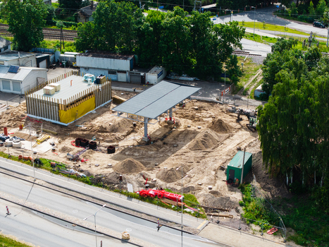 Riga Latvia 04 July 2026 Aerial view of a gas station under construction in the Zemgale Suburb featuring a new canopy building foundations and sandy ground near a road.