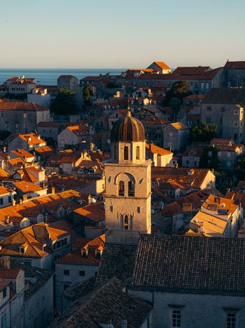 View of the historic Dubrovnik Old Town featuring a prominent bell tower surrounded by terracotta rooftops at sunset Dubrovnik Dubrovnik Neretva County Croatia. View of the historic Dubrovnik Old Town featuring a prominent bell tower surrounded by terracotta rooftops at sunset Dubrovnik Dubrovnik Neretva County Croatia.