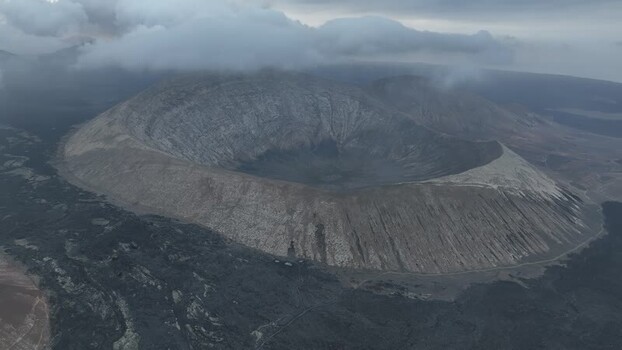 Aerial view of a volcanic crater under clouds in Lanzarote Spain.