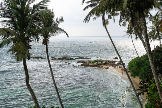 View of Secret Beach Mirissa with palm trees turquoise ocean waves and rocky formations Mirissa Southern Province Sri Lanka. View of Secret Beach Mirissa with palm trees turquoise ocean waves and rocky formations Mirissa Southern Province Sri Lanka.