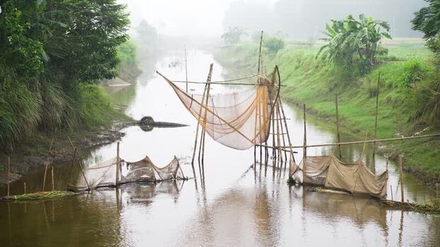 View of traditional bamboo fishing nets in a river Bangladesh.