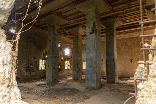View of the weathered concrete interior of the historic North Field Base featuring exposed rebar and structural columns in Northern Tinian Tinian Northern Mariana Islands. View of the weathered concrete interior of the historic North Field Base featuring exposed rebar and structural columns in Northern Tinian Tinian Northern Mariana Islands.