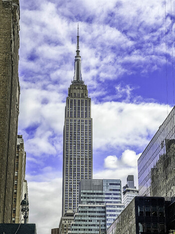 New York New York United States 28 November 2022 View of the Empire State Building in Midtown Manhattan featuring its iconic Art Deco architecture against a blue sky.