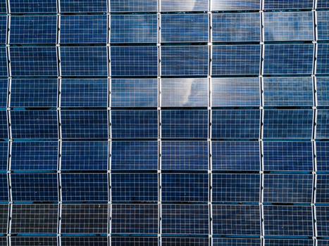 Aerial view of the SolarSea floating solar power plant with a grid of blue photovoltaic panels reflecting the sky in Dharavandhoo Baa Atoll Maldives. Aerial view of the SolarSea floating solar power plant with a grid of blue photovoltaic panels reflecting the sky in Dharavandhoo Baa Atoll Maldives.