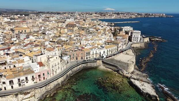 Aerial view of Ortigia Island and Mount Etna in Syracuse Italy.
