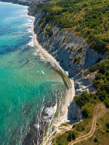 Aerial view of the White Cliffs of Byala featuring dramatic limestone formations turquoise Black Sea waters and lush green coastal vegetation in Byala Varna Bulgaria. Aerial view of the White Cliffs of Byala featuring dramatic limestone formations turquoise Black Sea waters and lush green coastal vegetation in Byala Varna Bulgaria.