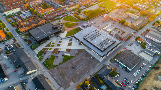 Aerial view of a modern building complex with a water slide parking areas and surrounding residential streets in Sweden. Aerial view of a modern building complex with a water slide parking areas and surrounding residential streets in Sweden.