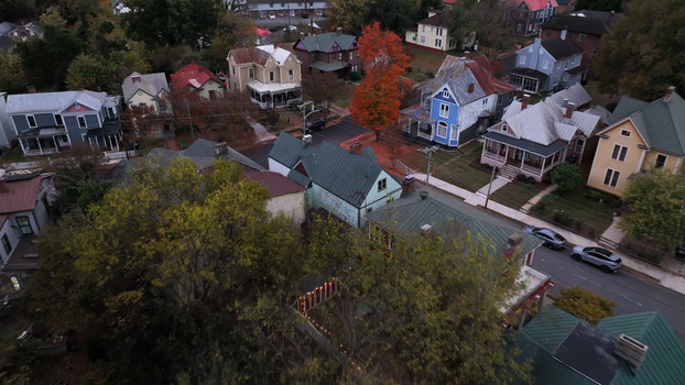 Aerial view of a residential neighborhood with historic houses and vibrant autumn foliage lining the streets in Danville Virginia United States.