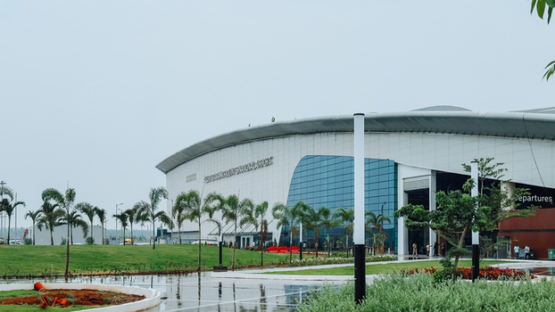 Bhogapuram Andhra Pradesh India 22 August 2026 View of Alluri Sitarama Raju International Airport with its modern glass facade curved roof and landscaped grounds. Bhogapuram Andhra Pradesh India 22 August 2026 View of Alluri Sitarama Raju International Airport with its modern glass facade curved roof and landscaped grounds.