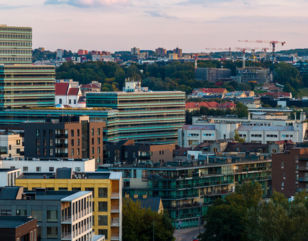 Aerial view of the modern skyline of Vilnius featuring contemporary glass office buildings residential apartment blocks and construction cranes in Vilnius Vilnius County Lithuania. Aerial view of the modern skyline of Vilnius featuring contemporary glass office buildings residential apartment blocks and construction cranes in Vilnius Vilnius County Lithuania.