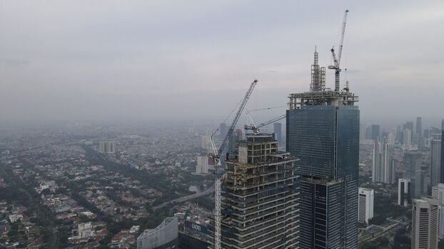 Kecamatan Menteng Daerah Khusus Ibukota Indonesia 03 December 2021 Aerial view of skyscrapers under construction with tower cranes in Jakarta Pusat. Kecamatan Menteng Daerah Khusus Ibukota Indonesia 03 December 2021 Aerial view of skyscrapers under construction with tower cranes in Jakarta Pusat.