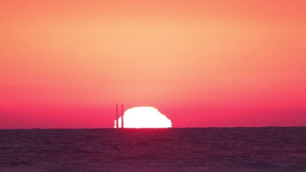 View of the intense red sun over the sea France.