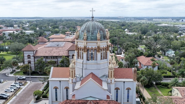 Aerial view of Memorial Presbyterian Church with its distinctive dome and terracotta roof tiles surrounded by the historic urban landscape of St. Augustine Florida United States.