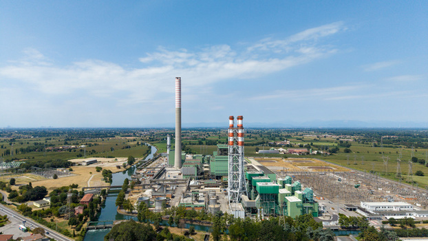 Aerial view of the Tavazzano power plant a natural gas facility with tall chimneys and industrial infrastructure situated near a canal in Tavazzano con Villavesco Lombardy Italy.