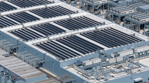 Aerial view of the HGB industrial facility featuring extensive rooftop solar panel arrays and complex cooling infrastructure in Winschoten Groningen Netherlands.