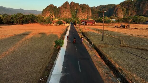 Aerial view of a road leading to karst mountains in Maros Indonesia. Aerial view of a road leading to karst mountains in Maros Indonesia.