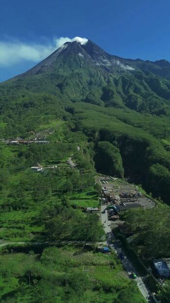 Aerial view of Mount Merapi volcano and lush slopes in Indonesia.