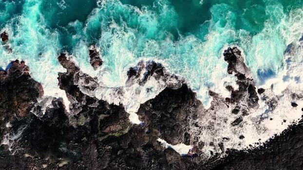 Aerial view of waves crashing on Kalaemamo rocks United States.