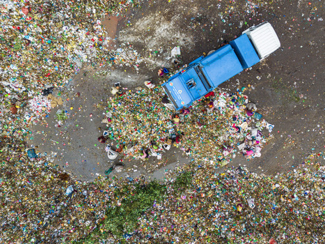 Aminbazar Bangladesh 26 January 2025 Aerial view of waste pickers sorting through piles of colorful plastic trash next to a blue garbage truck at the Aminbazar landfill. Aminbazar Bangladesh 26 January 2025 Aerial view of waste pickers sorting through piles of colorful plastic trash next to a blue garbage truck at the Aminbazar landfill.