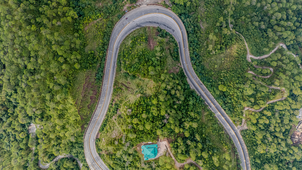 Aerial view of the Islamabad Murree Expressway winding through the lush green forested hills of Lower Topa Punjab Pakistan. Aerial view of the Islamabad Murree Expressway winding through the lush green forested hills of Lower Topa Punjab Pakistan.