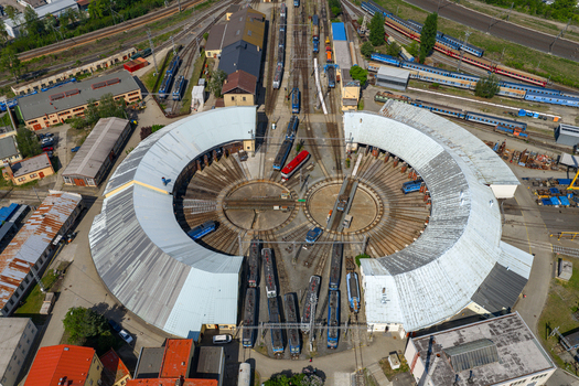 Aerial view of a circular railway roundhouse with multiple tracks and trains parked in a depot in Prague Prague Czechia.